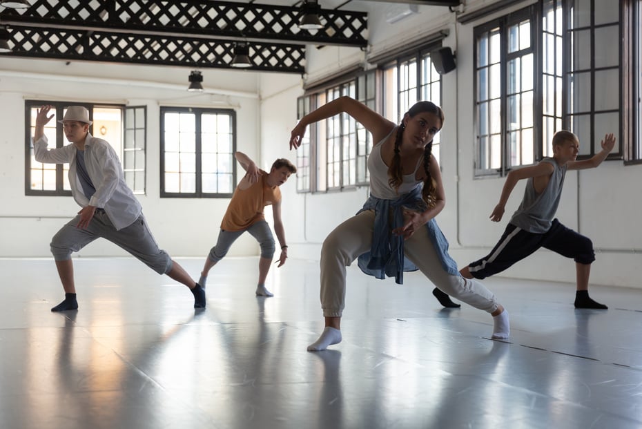 Teenagers training contemporary dance at studio